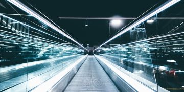 gray conveyor between glass frames at nighttime