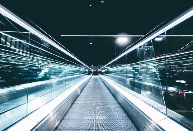 gray conveyor between glass frames at nighttime