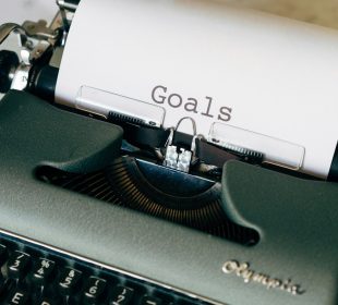 black and white typewriter on green textile
