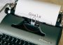black and white typewriter on green textile